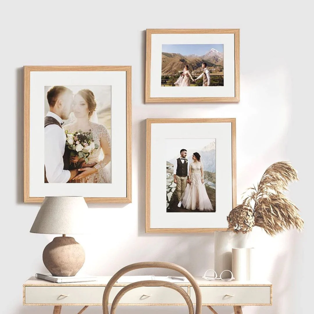 Gallery Wall Of Nautral Wood Picture Frames With Wedding Photos